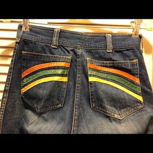 Vintage used jeans with ribbon decor sewn on rear pickets.